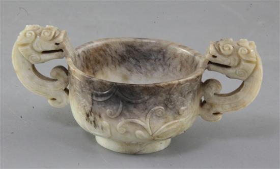 A Chinese cream and black jade two handled cup, 16th/17th century, width 13cm